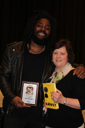 Christina Giving Jason Reynolds an Ohio Buckeye Childrens and Teen Book Award
